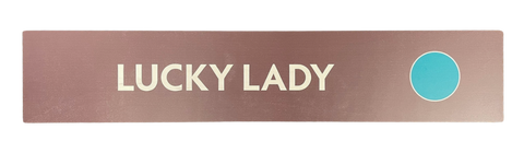 Wooden trail sign with the text, 'Lucky Lady' and a green circle icon
