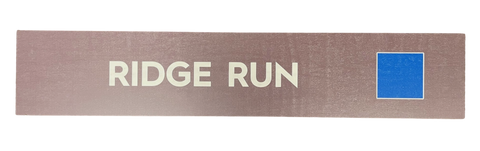 Wooden trail sign with the text, 'Ridge Run' and a blue square icon