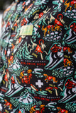 Close-up of a patterned fabric with various designs and text on a black background.