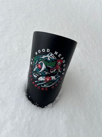 black pint cup featuring whimsical painting of rescue dogs and a mountain. 