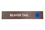 Rectangular sign with 'BEAVER TAIL' text on a brown background