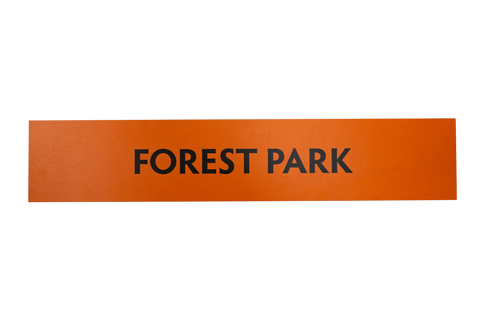 Rectangular orange sign with 'FOREST PARK' text on a white background