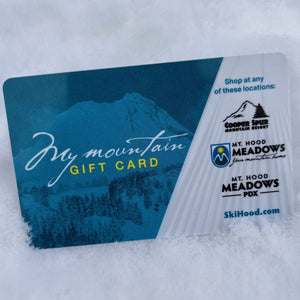 A blue and white gift card sitting on top of fresh snow