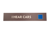 Rectangular brown sign with 'I Hear Cars' text and a blue square icon
