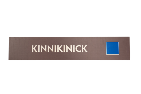 Rectangular brown sign with 'Kinnikinick' text