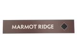 Rectangular brown sign with 'Marmot Ridge' text 