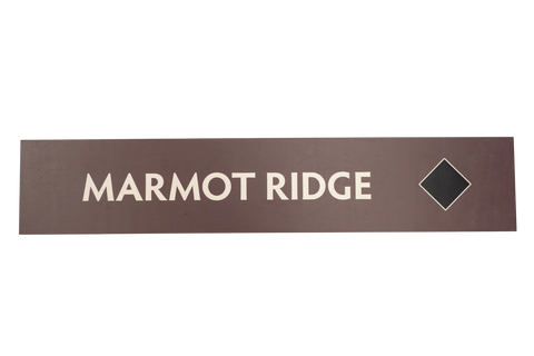 Rectangular brown sign with 'Marmot Ridge' text 