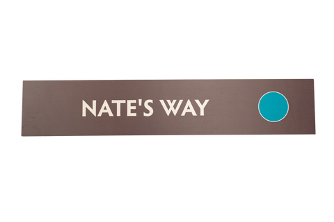 Brown rectangular sign with 'Nate's Way' text and a blue circle 