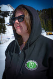 Person standing in front of Mt. Hood. They are wearing sunglasses and a hooded sweatshirt.