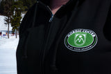 Close up image of the Mt. Hood Meadows Nordic Center logo on a zip hood.