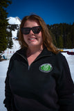 Person standing in front of Mt.Hood in a black quarter zip sweater.