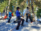 Group of people preparing for a winter activity in a snowy forest