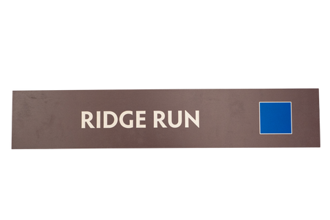 Rectangular sign with 'RIDGE RUN' text on a brown background