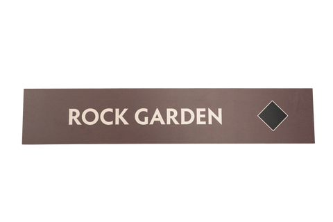 Rectangular brown sign with 'ROCK GARDEN' text with a black diamond icon