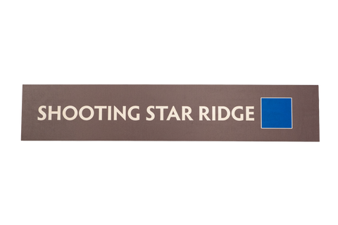 Rectangular brown sign with 'SHOOTING STAR RIDGE' text and a blue square icon