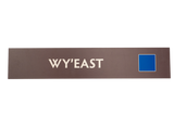 Rectangular brown sign with 'Wy'East' text and a blue square icon
